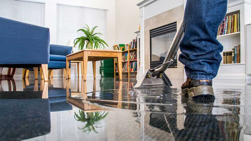 Man clearing water at a home property